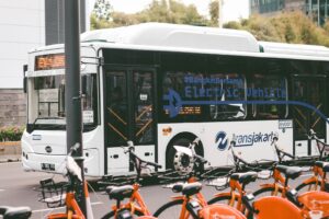 a city bus parked next to a bunch of bikes